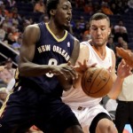 Phoenix Suns center Miles Plumlee (22), right, knocks the ball away from New Orleans Pelicans small forward Al-Farouq Aminu (0) in the first quarter during an NBA basketball game on Sunday, Nov. 10, 2013, in Phoenix. (AP Photo/Rick Scuteri)