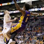  Phoenix Suns' Alex Len, left, of Ukraine, knocks Los Angeles Lakers' Nick Young (0) to the ground for a flagrant foul as Young attempted a layup during the first half of an NBA basketball game Wednesday, Jan. 15, 2014, in Phoenix. Both players were ejected from the game. (AP Photo/Ross D. Franklin)