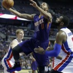Phoenix Suns forward Markieff Morris (11) goes to the basket against Detroit Pistons center Andre Drummond (0) during the first half of an NBA basketball game, Saturday, Jan. 11, 2014, in Auburn Hills, Mich. (AP Photo/Duane Burleson)