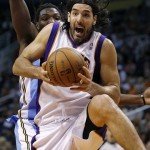 Phoenix Suns' Luis Scola, of Argentina, pulls down a rebound against the Denver Nuggets during the second half of an NBA basketball game, Monday, March 11, 2013, in Phoenix. (AP Photo/Matt York