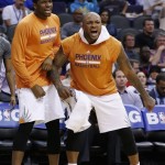  Phoenix Suns' P.J. Tucker, right, and Dionte Christmas cheers on their team from the bench during the first half of an NBA basketball game against the Indiana Pacers Wednesday, Jan. 22, 2014, in Phoenix. (AP Photo/Ross D. Franklin)