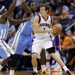 Phoenix Suns' Goran Dragic (1), of Slovenia, looks to pass around Denver Nuggets' Kenneth Faried (35) and Corey Brewer during the first half of an NBA basketball game, Monday, March 11, 2013, in Phoenix. (AP Photo/Matt York)