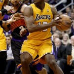 Los Angeles Lakers' Metta World Peace drives the baseline against Phoenix Suns' Jared Dudley during the first half of an NBA basketball game, Wednesday, Jan. 30, 2013, in Phoenix. (AP Photo/Matt York)