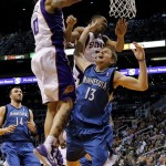 Minnesota Timberwolves' Luke Ridnour (13) has his shot blocked by Phoenix Suns' Michael Beasley (0) as Suns' Wesley Johnson also defends during the first half of an NBA basketball game on Friday, March 22, 2013, in Phoenix. (AP Photo/Matt York)