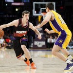 Phoenix Suns' Goran Dragic, left, of Slovenia, controls the ball against Los Angeles Lakers' Steve Nash, right, during the first half of an NBA basketball game, Tuesday, Feb. 12, 2013, in Los Angeles. (AP Photo/Danny Moloshok)