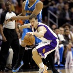Phoenix Suns' Goran Dragic, of Slovenia chases down a loose ball as New Orleans Hornets' Anthony Davis, rear, defends during the first half of an NBA basketball game, Sunday, April 7, 2013, in Phoenix. (AP Photo/Matt York)
