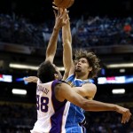 New Orleans Hornets' Robin Lopez has his shot blocked by Phoenix Suns' Hamed Haddadi (98), of Iran, during the first half of an NBA basketball game, Sunday, April 7, 2013, in Phoenix. (AP Photo/Matt York)