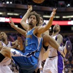 New Orleans Hornets' Robin Lopez (15) battles Phoenix Suns' Luis Scola, of Argentina, for the ball during the first half of an NBA basketball game, Sunday, April 7, 2013, in Phoenix. (AP Photo/Matt York)