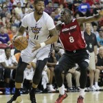 Phoenix Suns' Markieff Morris (11) drives to the basket against Miami Heat's James Ennis (8) in the first quarter of an NBA Summer League basketball game on Sunday, July 21, 2013, in Las Vegas. (AP Photo/Julie Jacobson)