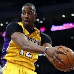 Los Angeles Lakers' Dwight Howard pulls in a defensive rebound against the Phoenix Suns during the first half of an NBA basketball game on Tuesday, Feb. 12, 2013, in Los Angeles. The Lakers won 91-85. Howard finished with 19 points and 18 rebounds. (AP Photo/Danny Moloshok)
