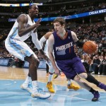 Phoenix Suns guard Goran Dragic, of Slovenia, drives the lane for a shot as Denver Nuggets center J.J. Hickson, left, and guard Randy Foye defend during the first quarter of an NBA basketball game in Denver on Tuesday, Feb. 18, 2014. (AP Photo/David Zalubowski)
