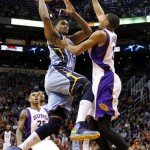 Memphis Grizzlies' Rudy Gay drives to the basket as Phoenix Suns' Wesley Johnson, right, defends during the first half of an NBA basketball game, Sunday, Jan. 6, 2013, in Phoenix. (AP Photo/Matt York)