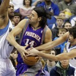 Phoenix Suns' Luis Scola, center, of Argentina, tries to hang onto the ball as he is double teamed by Minnesota Timberwolves' Dante Cunningham, left, and Ricky Rubio, of Spain, in the first quarter of an NBA basketball game on Saturday, April 13, 2013, in Minneapolis. (AP Photo/Jim Mone)