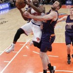 New York Knicks' Raymond Felton (2) drives past Phoenix Suns' Miles Plumlee (22) during the first half of an NBA basketball game Monday, Jan. 13, 2014, in New York. (AP Photo/Frank Franklin II)