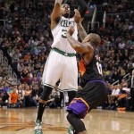 Boston Celtics forward Paul Pierce, left, attempts to score over Phoenix Suns forward P.J. Tucker, right, in the first half of an NBA basketball game, Friday, Feb. 22, 2013, in Phoenix. (AP Photo/Paul Connors)