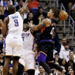 Phoenix Suns' Michael Beasley (0) has his shot blocked by Oklahoma City Thunder's Kendrick Perkins, center, as Serge Ibaka (9), of the Congo, comes in to defend during the first half in an NBA basketball game, Sunday, Feb. 10, 2013, in Phoenix. (AP Photo/Ross D. Franklin)
