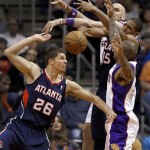 Atlanta Hawks' Kyle Korver (26) and Al Horford (15) battle Phoenix Suns' P.J. Tucker, right, and Marcin Gortat, of Poland, rear, for a loose ball during the first half of an NBA basketball game, Friday, March 1, 2013, in Phoenix. (AP Photo/Matt York)