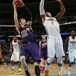 Phoenix Suns guard Goran Dragic, left, of Slovenia, goes up for shot as Denver Nuggets guard Randy Foye defends during the first quarter of an NBA basketball game in Denver on Tuesday, Feb. 18, 2014. (AP Photo/David Zalubowski)
