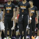 Phoenix Suns' Marcus Morris (15) and his brother Markieff Morris (11) walk back onto the court after a timeout against the Portland Trail Blazers in the second quarter of an NBA Summer League basketball game on Saturday, July 13, 2013, in Las Vegas. (AP Photo/Julie Jacobson)
