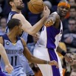 Memphis Grizzlies' Marc Gasol and Phoenix Suns' Jermaine, O'Neal, right, reach for a loose ball during the first half of an NBA basketball game, Sunday, Jan. 6, 2013, in Phoenix. (AP Photo/Matt York)
