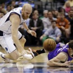 Phoenix Suns guard Goran Dragic (1), right, of Slovenia, is fouled by Dallas Mavericks center Chris Kaman during the first half of an NBA basketball game, Wednesday, April 10, 2013, in Dallas. (AP Photo/LM Otero)