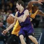 Phoenix Suns guard Goran Dragic, front, of Slovenia, is fouled while drivng for a shot by Denver Nuggets forward Darrell Arthur late in the fourth quarter of the Suns' 103-102 victory in an NBA basketball game in Denver on Friday, Dec. 20, 2013. (AP Photo/David Zalubowski)