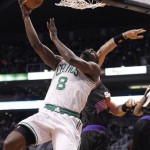 Boston Celtics forward Brandon Bass, left, lays up a shot over Phoenix Suns center Marcin Gortat, right, of Poland, in the first half of an NBA basketball game, Friday, Feb. 22, 2013, in Phoenix. (AP Photo/Paul Connors)