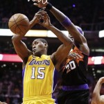 Los Angeles Lakers' Metta World Peace (15) gets his shot blocked by Phoenix Suns' Jermaine O'Neal (20) in the first half of an NBA basketball game on Monday, March 18, 2013, in Phoenix. (AP Photo/Ross D. Franklin)