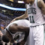 Boston Celtics forward Jeff Green, left, reacts after being poked in the eye as teammate Courtney Lee, right, checks on him against the Phoenix Suns in the first half of an NBA basketball game, Friday, Feb. 22, 2013, in Phoenix. (AP Photo/Paul Connors)