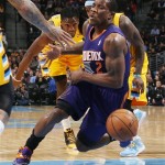 Phoenix Suns guard Eric Bledsoe, front, reacts as he is fouled while driving the lane by Denver Nuggets guard Ty Lawson, center, as forward Kenneth Faried trails the play in the first quarter of an NBA basketball game in Denver on Friday, Dec. 20, 2013. (AP Photo/David Zalubowski)
