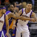 Sacramento Kings' Marcus Thornton, center, knocks the ball away from Phoenix Suns' Diante Garrett, right, as Suns' Jared Dudley (3) looks on during the first half of an NBA basketball game on Thursday, March 28, 2013, in Phoenix. (AP Photo/Matt York)