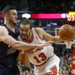 Chicago Bulls center Joakim Noah (13) drives on Phoenix Suns center Miles Plumlee during the second half of an NBA basketball game, Tuesday, Jan. 7, 2014, in Chicago. The Bulls won 92-87. (AP Photo/Charles Rex Arbogast)