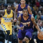 Phoenix Suns guard Eric Bledsoe, front, picks up the loose ball Denver Nuggets forward J.J. Hickson, back left, and Suns center Channing Frye follow the play in the first quarter of an NBA basketball game in Denver on Friday, Dec. 20, 2013. (AP Photo/David Zalubowski)