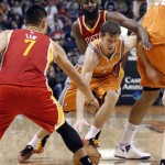 Phoenix Suns guard Goran Dragic, center, drives between Houston Rockets defenders Jeremy Lin, front, and James Harden, rear, on his way to the basket during the second half of an NBA basketball game Saturday, March 9, 2013, in Phoenix. The Suns won 107-105. (AP Photo/Paul Connors)
