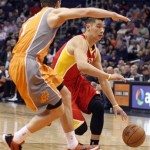 Houston Rockets guard Jeremy Lin, right, is guarded by Phoenix Suns guard Goran Dragic, left, of Slovenia, during the first half of an NBA basketball game Saturday, March 9, 2013, in Phoenix.(AP Photo/Paul Connors)
