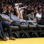 Los Angeles Lakers' Steve Blake falls over empty courtside chairs as he tries to save a ball from going out of bounds against the Phoenix Suns during the first half of an NBA basketball game on Tuesday, Feb. 12, 2013, in Los Angeles. (AP Photo/Danny Moloshok)