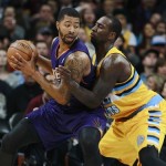 Phoenix Suns forward Markieff Morris, left, works the ball inside for a shot as Denver Nuggets forward J.J. Hickson covers in the fourth quarter of the Suns' 103-102 victory in an NBA basketball game in Denver on Friday, Dec. 20, 2013. (AP Photo/David Zalubowski)
