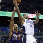 Orlando Magic's Jameer Nelson (14) attempts a shot over Phoenix Suns' Channing Frye (8) during the second half of an NBA basketball game in Orlando, Fla., Sunday, Nov. 24, 2013. The Phoenix Suns won 104-96. (AP Photo/John Raoux)