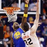  Phoenix Suns' Miles Plumlee (22) tries to get off a shot over Golden State Warriors' Jermaine O'Neal (7) during the first half of an NBA basketball game Saturday, Feb. 8, 2014, in Phoenix. (AP Photo/Ross D. Franklin)