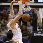  Phoenix Suns' Miles Plumlee, right, dunks as Indiana Pacers' Paul George (24) looks on during the first half of an NBA basketball game, Wednesday, Jan. 22, 2014, in Phoenix. (AP Photo/Ross D. Franklin)