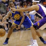 Golden State Warriors' Harrison Barnes (40) passes around Phoenix Suns' Jared Dudley during the first half of an NBA basketball game on Friday, April 5, 2013, in Phoenix. (AP Photo/Matt York)