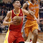 Houston Rockets guard Jeremy Lin, left, drives to the basket past Phoenix Suns forward Wesely Johnson, right, during the first half of an NBA basketball game on Saturday, March 9, 2013, in Phoenix. (AP Photo/Paul Connors)
