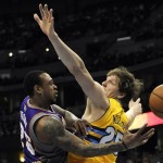 Phoenix Suns guard Shannon Brown, left, passes around Denver Nuggets center Timofey Mozgov, right, of Russia, in the second half of an NBA basketball game on Wednesday, April 17, 2013, in Denver. The Nuggets won 118-98. (AP Photo/Chris Schneider)