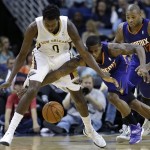 New Orleans Pelicans small forward Al-Farouq Aminu (0) and Phoenix Suns point guard Eric Bledsoe (2) battle for a loose ball in the first half of an NBA basketball game in New Orleans, Tuesday, Nov. 5, 2013. (AP Photo/Gerald Herbert)