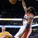  Washington Wizards' Nene, right, of Brazil, dunks as Phoenix Suns' Miles Plumlee (22) looks on during the first half of an NBA basketball game, Friday, Jan. 24, 2014, in Phoenix. (AP Photo/Ross D. Franklin)