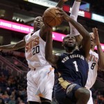 
New Orleans Pelicans point guard Tyreke Evans (1) drives between Phoenix Suns shooting guard Archie Goodwin (20) and forward Channing Frye (8) in the second quarter during an NBA basketball game on Sunday, Nov. 10, 2013, in Phoenix. (AP Photo/Rick Scuteri)