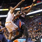 Atlanta Hawks' Elton Brand (42) shoots in front of Phoenix Suns' Channing Frye during the first half of an NBA basketball game, Sunday, March 2, 2014, in Phoenix. (AP Photo/Matt York)
