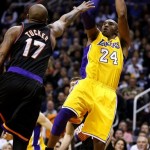 Los Angeles Lakers' Kobe Bryant (24) shoots over Phoenix Suns' P.J. Tucker (17) during the first half on an NBA basketball game, Wednesday, Jan. 30, 2013, in Phoenix. (AP Photo/Matt York)