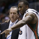 Milwaukee Bucks coach Jim Boylan talks with Luc Richard Mbah a Moute, right, during the first half of an NBA basketball game against the Phoenix Suns on Tuesday, Jan. 8, 2013, in Milwaukee. (AP Photo/Jeffrey Phelps)