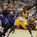 Los Angeles Lakers' Kobe Bryant, right, is defended by Phoenix Suns' Markieff Morris during the first half of a preseason NBA basketball game on Tuesday, Oct. 21, 2014, in Anaheim, Calif. (AP Photo/Jae C. Hong)